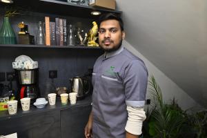 a man standing in front of a counter with his arm in a cast at شقق لافيدا الفندقية in Riyadh