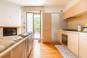 a kitchen with a long couch in a room at Modern Apartment in La Spezia with Stunning Views - 75 m² in La Spezia +26 photos