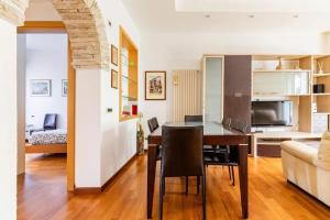 a dining room and living room with a table and a couch at Modern Apartment in La Spezia with Stunning Views - 75 m² in La Spezia