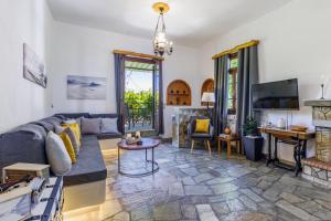 a living room with a couch and a fireplace at Efcharis house Skopelos in Neo Klima