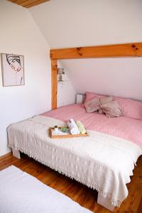 a bedroom with a bed with a wooden headboard at Holiday Home Ventura in Pihovec