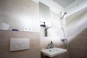 a bathroom with a white sink and a mirror at Kapelle Elbtalaue - Kirchensaal in Hitzacker +11 photos