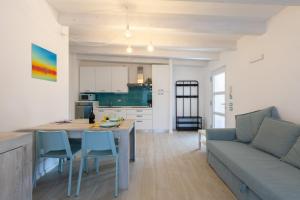 a kitchen and living room with a couch and a table at Conca d'Oro Apartments, appartamento 5 e 6 in Arco +41 photos
