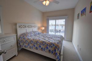 a bedroom with a bed and a window at Sea Star Village 314 in Surf City
