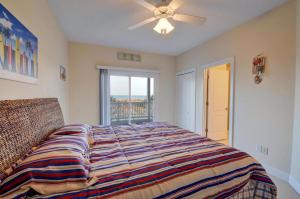 a bedroom with a large bed and a window at Sea Star Village 314 in Surf City