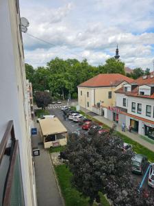 a view of a city with cars parked in a parking lot at HeyYou Apartment in Bjelovar