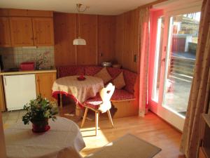 a living room with a table and a couch at Gästehaus Klara in Reit im Winkl +22 photos