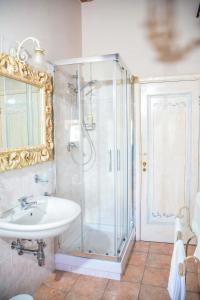 a bathroom with a shower and a sink and a mirror at Appartamento Santa Croce in Arezzo