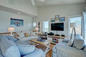 a living room with two couches and a tv at 3952 Island Drive in North Topsail Beach