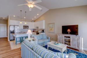a living room with a couch and a table at Sea Star Village 320 in West Onslow Beach