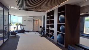 a fitness room with a gym with exercise equipment at P R A T U M Plus in Mikołajki