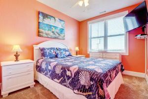 a bedroom with a bed and a window at 3970 Island Drive - It's a Wonderful Life in North Topsail Beach