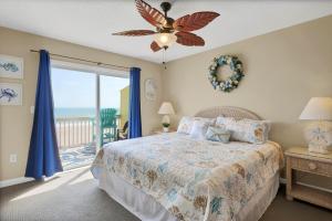a bedroom with a bed and a view of the ocean at 3958 Island Drive in North Topsail Beach