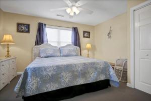 a bedroom with a bed and a ceiling fan at 3958 Island Drive in North Topsail Beach