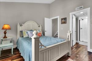 a bedroom with a bed with a blue bedspread at Surf Condos 737 in Surf City