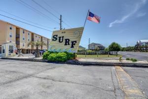 a sign for a hotel with an american flag at Surf Condos 737 in Surf City
