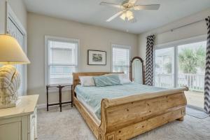 a bedroom with a bed and a ceiling fan at Sea Star Village 212 in Surf City