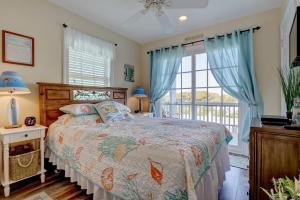 a bedroom with a bed and a large window at 3980 Island Drive - Sand Dollar in North Topsail Beach +46 photos
