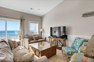 a living room with a couch and a tv at Sea Star Village 322 in West Onslow Beach