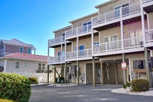 a apartment building with balconies and a parking lot at Sea Star Village 322 in West Onslow Beach
