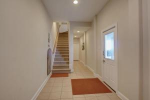 a hallway with a staircase and a stair case at Sea Star Village 322 in West Onslow Beach +26 photos