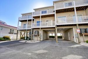 a large apartment building with a parking lot at Sea Star Village 322 in West Onslow Beach