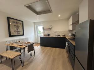 a kitchen with a table and a dining room at Brewe's Loft in Farden