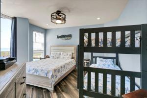 a bedroom with two bunk beds and a tv at St Regis 1105 in Chadwick Acres
