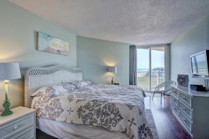 a bedroom with a bed and a tv and a window at St Regis 1405 - Sea of Dreams in North Topsail Beach
