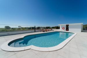 a swimming pool on the roof of a building at Marinhas Bed & Breakfast in Esposende