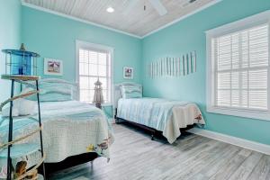 ノース・トップセール・ビーチにある4426 Island Drive - Saltwater Therapyの青いベッドルーム(ベッド1台、窓2つ付)