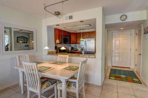 a dining room with a table and chairs and a kitchen at St Regis 3303 in Chadwick Acres +39 photos
