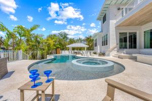 a pool with blue glasses on a table in front of a house at Beach Fanta Sea - 149 in Bailey Hall