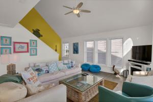 a living room with a couch and a table at 4444 Island Drive - Seahorse Sanctuary in North Topsail Beach