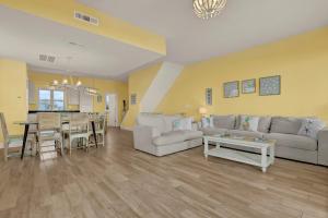 a living room with a couch and a table at 3974 Island Drive - Suit Up in North Topsail Beach