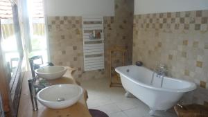 a bathroom with two sinks and a bath tub at "L'Ancienne Etable" Dordogne in Saint-Avit-Saint-Nazaire +21 photos