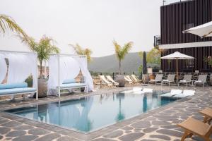 a swimming pool with lounge chairs and a hotel at Doria Luxury Boutique Hotel in Dishon