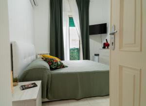 a bedroom with a bed and a window at Casa Pirandello in Terracina