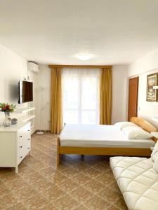 Postel nebo postele na pokoji v ubytování Jadran Apartments