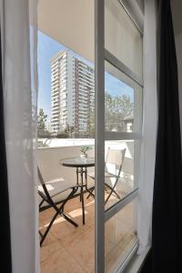 a balcony with a table and a view of a building at Hotel Boutique Trinidad in Viña del Mar
