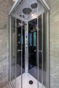 a walk in shower with glass doors in a room at Garden Apartment Relax in Barco +35 photos