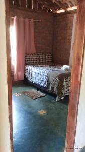 Ένα ή περισσότερα κρεβάτια σε δωμάτιο στο Camping e pousada dos sonhos