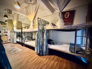 a room with two bunk beds in it at MINUM hostel in Ban Madua Wan