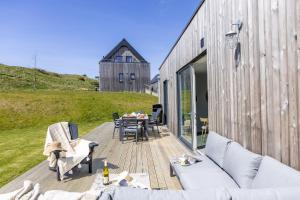a wooden deck with a table and chairs and a barn at No 6 The Vista, Willingcott, Woolacombe in Woolacombe