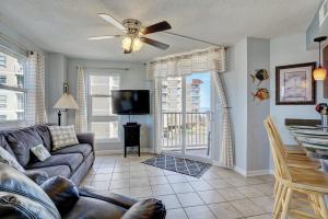 a living room with a couch and a tv at Relaxing oceanfront 1 Bedroom Condo in St. Regis Resort in Chadwick Acres