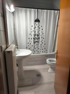 a bathroom with a sink and a shower curtain at Elli's House in Keramoti +66 photos