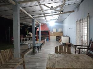 a room with benches and a table in a building at Finca LA Soñada in Santiago del Estero