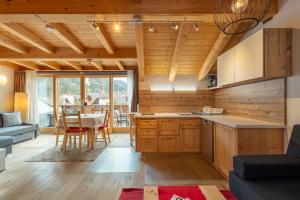 a kitchen and living room with a table and chairs at Apartments Irene in La Villa