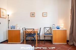 a dining room with a table and two chairs at Acquamarina by PortofinoVip in Portofino