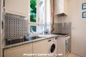 a kitchen with a sink and a washing machine at Acquamarina by PortofinoVip in Portofino